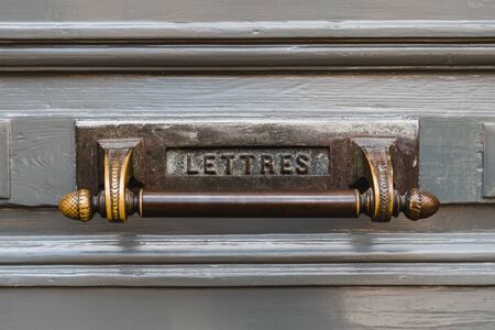 Letterbox with a gray door background. Close-up View of a Beautiful Letter Box with knobの写真素材