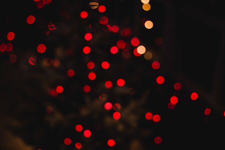 Holidays abstract glitter background. Red blur abstract bokeh light backgound form christmas night...