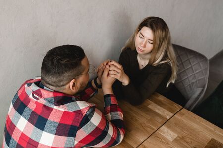 Man and woman dating in cafe. Happy guy and girl. Couple in love sitting at home and communicating. Close up of a happy couple enjoying time togetherの写真素材