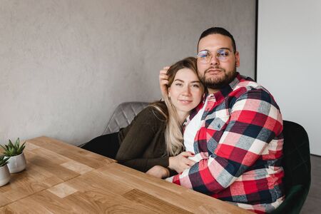 Man and woman dating in cafe. Happy guy and girl. Couple in love sitting at home and communicating. Close up of a happy couple enjoying time togetherの写真素材