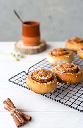 Freshly baked cinnamon buns with spices on a wooden background. Kanelbule - swedish dessert.の写真素材