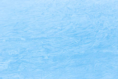Abstract ice texture. Nature background. Traces of blades of skates on ice