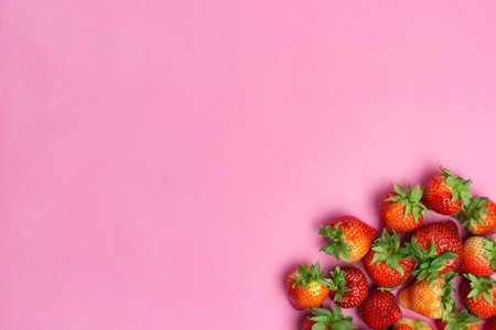 Strawberries isolated on pink background. Fresh berry flat lay. Creative food conceptの写真素材