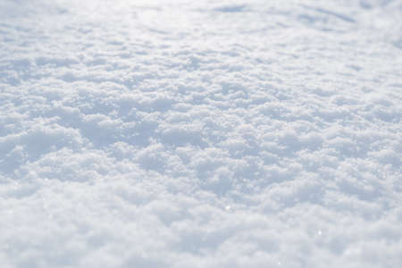 Snow texture. Top view of the white snow. Background with copy space. Winter timeの写真素材