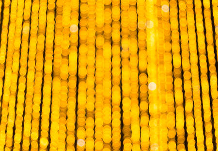 Yellow bokeh balls background. Golden holiday glowing backdrop. Defocused Background With Blinking Starsの写真素材