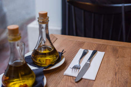 oil bottles and cutlery on the tableの写真素材