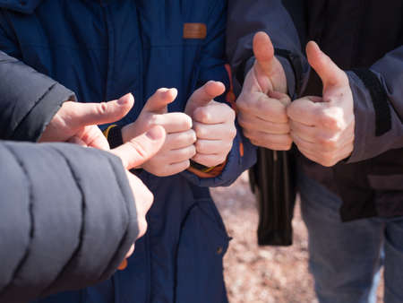 Young people showing thumbs upの写真素材