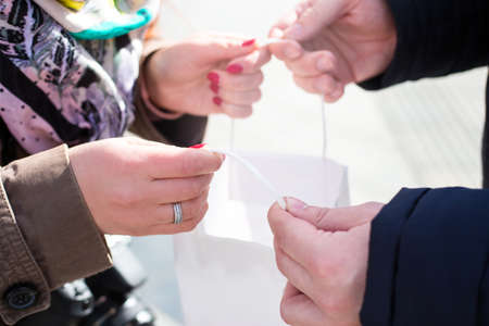 Sale in black Friday. Girl show their purchases to a young guy.の写真素材