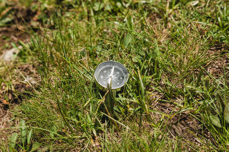 Lost Compass on nature background, ready to travel, keep calm. Tourism, traveling, hiking and healthy lifestyle concept.の写真素材
