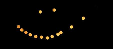 Decorative outdoor string lights at night time, Defocused Background, night city life backdrop, party time with Yellow bokeh balls, summertimeの写真素材