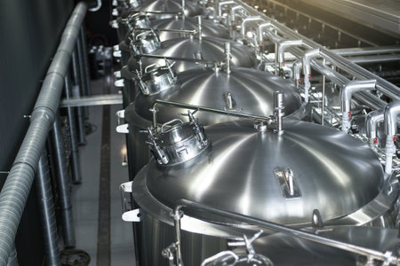 Modern Beer Factory. Steel tanks for beer fermentation and storage. Brewery. Modern beer plant with...