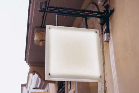 Blank white square store signboard. Illuminated lightbox on a wall. Mock up.の写真素材