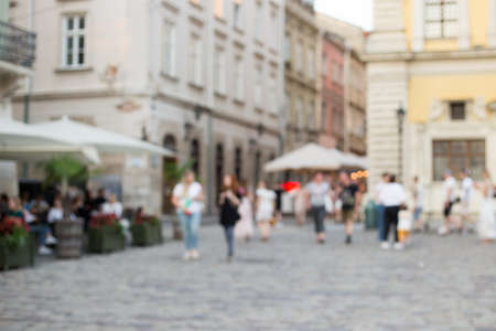 Blurred Defocused background of walking street with crowd people hang out and enjoy sunny day in old town, background for decorative advertisement.の写真素材