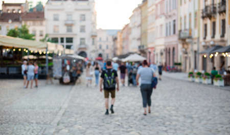 Blurred Defocused background of walking street with crowd people hang out and enjoy sunny day in old town, background for decorative advertisement.の写真素材