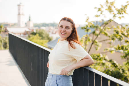 Photo of fashionable girl with beautiful red hair smiling to camera. Summer time, travel conceptの写真素材