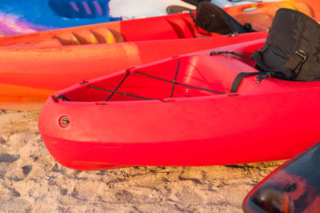 A few kayaks stand on a sandy beach. Outdoor water sports. Surfing lifestyle concepの写真素材