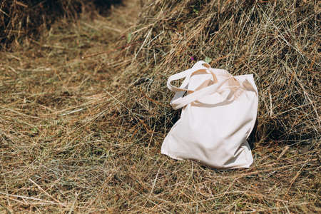 White canvas fabric bag for mockup blank template isolated on nature background. Zero waste concept....