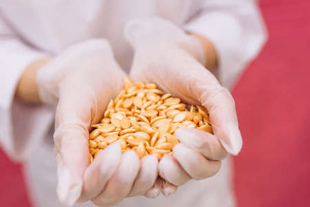 Wax for depilation of yellow color in the form of a heart. The concept of depilation, waxing, smooth...