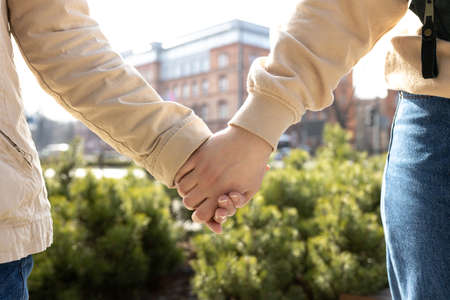 Hand of LGBT women holding together. Love, Care for the elderly concept. Close up woman covering hands of mature senior motherの写真素材