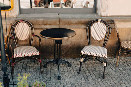 Empty tables in between dining hours. Old fashioned cafe terrace in a summer warm dayの写真素材