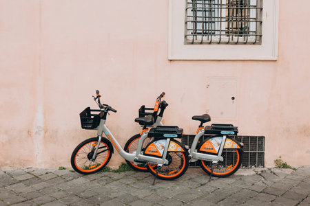 Rome, Italy - April 04, 2022 Electric Bicycle sharing system rentals with basket on a sidewalk in street of Rome. Company RideMoviのeditorial素材