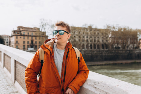 Happy young man walking on city street, Urban lifestyle concept. Travelerの写真素材