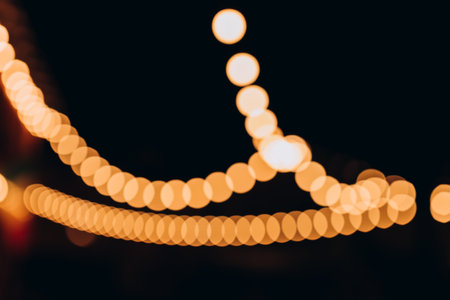 Decorative outdoor string lights at night time, Defocused Background, night city life backdrop,...