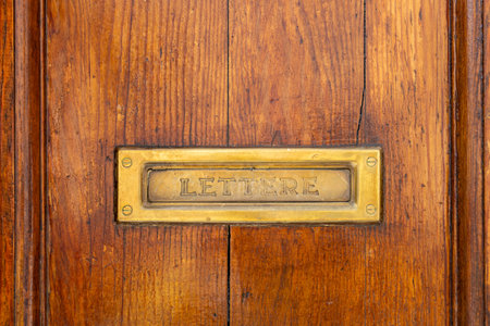 Letterbox on a brown door background. Close-up View of a Beautiful old Letter Box, Correspondenceの写真素材