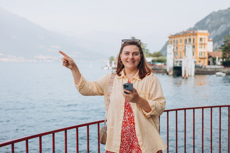 Happy brunette 30s woman enjoying summer holidays. Concept of vacation. Varenna, Italy. Lake Como....