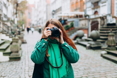Woman photographer with camera taking pictures outdoor at autumn day. Home hobby, lifestyle, travel,...