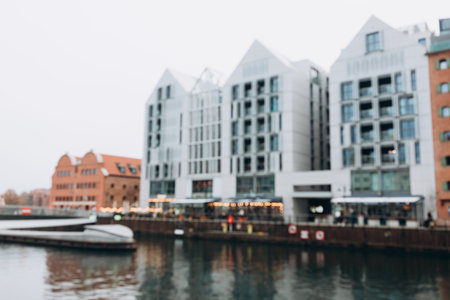 Blurred background of canal outside, modern city backdrop. Gdansk, Poland