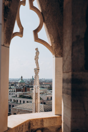Roof of Milan Cathedral Duomo di Milano with Gothic spires and white marble statues. Top tourist attraction on piazza in Milan, Lombardia, Italy. Gothic architectural fragment, panorama of cityの写真素材