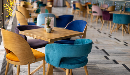 Modern interior of urban restaurant or cafe with dining places, daytime