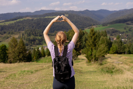 Freedom and active lifestyle concept. Adventure 30s women making by hands in shape of love heart....