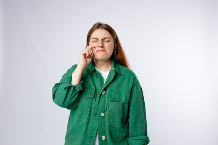 Sad crying disappointed funny woman isolated on background, Emotional, young face. Human emotions, facial expression concept.の写真素材