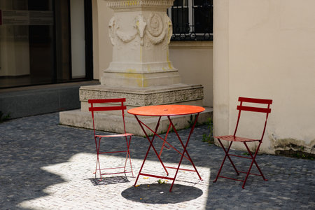 Empty cafe with terrace with red table and chairs. Street exterior of restaurant. Furniture for coffee shop in street in Europe in summer.の写真素材