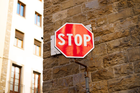Stop sign up against an old brick wall. Attention and alert sign.