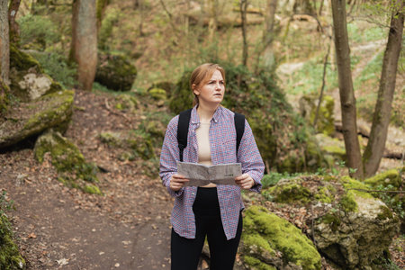 Stressed 30s Woman with map Lost in the Woods, Losing the Tracks. Confused hiker feeling frustrated...