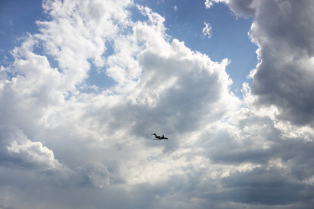 Passenger airplane flying in the sky amazing clouds in the background. Travel by air transport.の写真素材