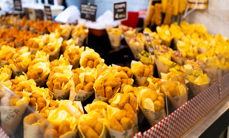 Tasty crispy chicken nuggets in a paper cones. Paper Cones containing chicken on sale at the local...