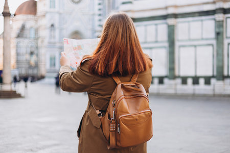 Tourist with map in old town Florence. Holidays and tourism concept. Person searching direction on location map while traveling abroad in autumnの写真素材