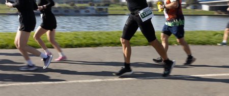Motion blurred marathon runners in a city. Group of marathon runners compete in the race outdoorsの写真素材