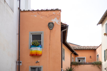 Rainbow flag hanging out of a window during the Pride festivalの写真素材