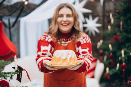 Lemon, vanilla marble bund cake in woman hands. Happy 30s girl standing near decorated Christmas tree. Winter time and holidays. Celebration banner,の写真素材