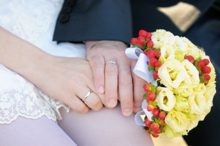 Bride and groom s hands with wedding ringsの写真素材
