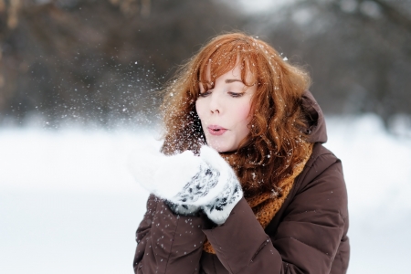 Outdoors portrait of young beautiful woman having fun in winter の写真素材