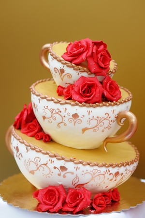 Delicious original wedding cake decorated with red flowersの写真素材