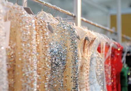 A few beautiful wedding or evening dresses on a hangerの写真素材