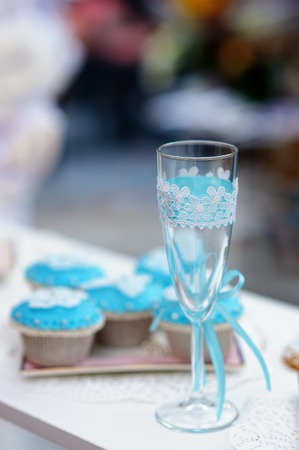 Stylish champagne glass and blue cupcakesの写真素材