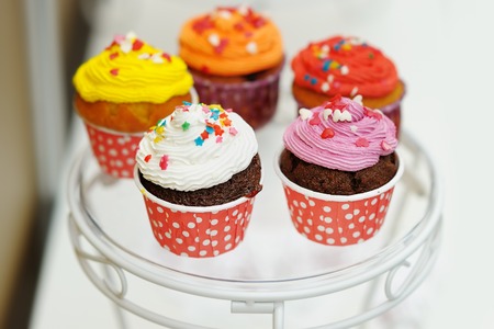 Multicolor cupcakes on glass plate の写真素材